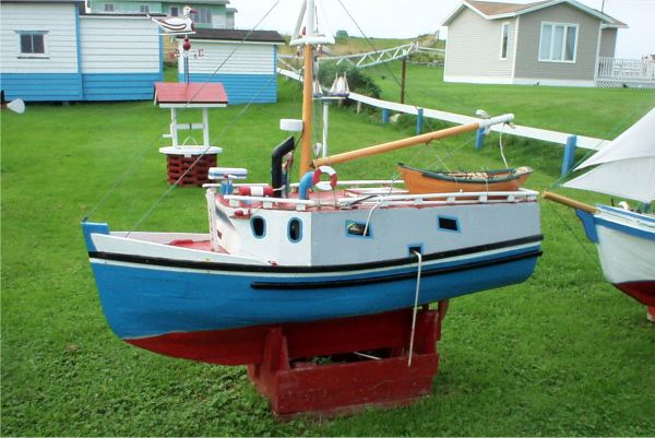 674: A model boat on Lawrence Barry's front lawn in St. Bride's. (2004)675: A model boat on Lawrence Barry's front lawn in St. Bride's. (2004)